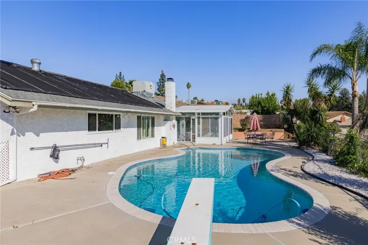 Pool area with diving board.