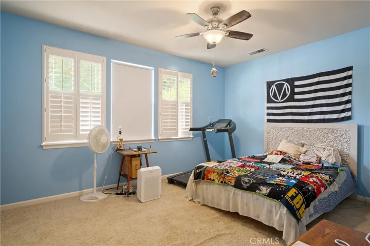 Front bedroom with tall ceilings and plantation shutters