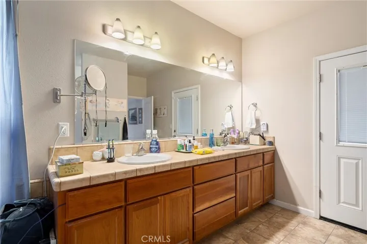 Primary bath has double sinks and lots of storage