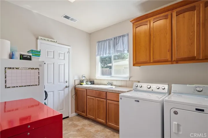 Giant laundry/mudroom with extra half bath and acces to rear yard