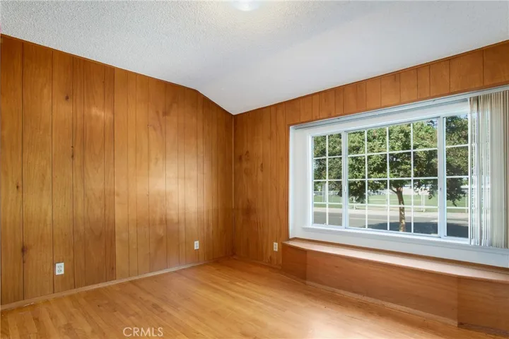 Front bedroom has an oversized window and built in bench with storage