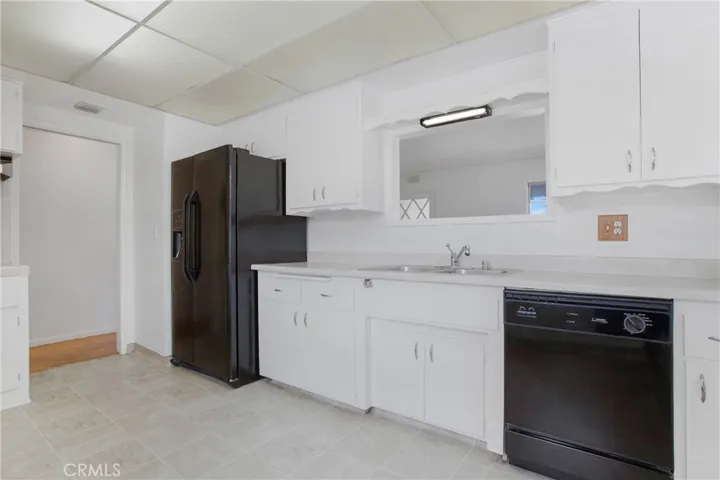 Bright white kitchen with view into the front room