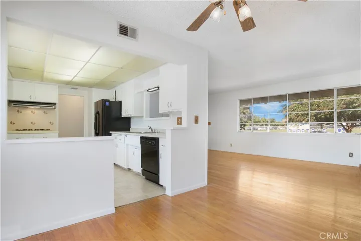 View from dining space to front room and kitchen