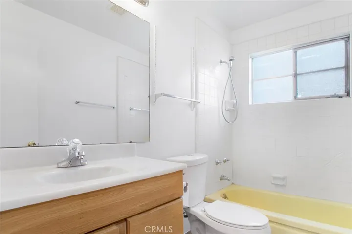 Full bathroom with shower over tub in the hallway