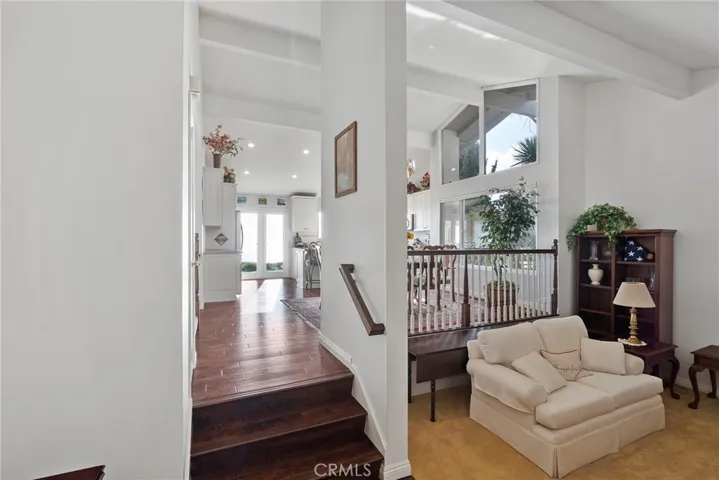 Coming in from the Front Double Doors and Covered Entry way, one step down is a spacious Living Room. Cathedral Ceilings add to the Bright, Open Flow and connection to the dining room and Kitchen.