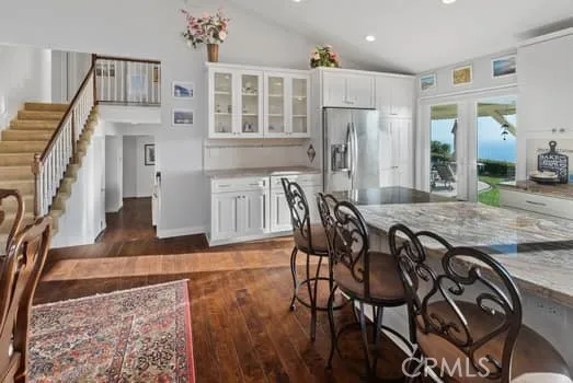 Notice the rich dark Hardwood Flooring in these rooms. View of the wall of storage and display counters by the built in Refrigerator.