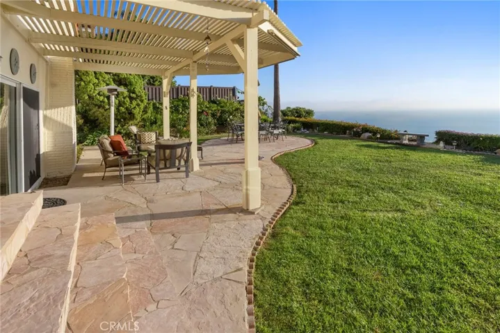 Extensive Patios and Grassy Yard for pets. Property continues down the slope and can be completely fenced.