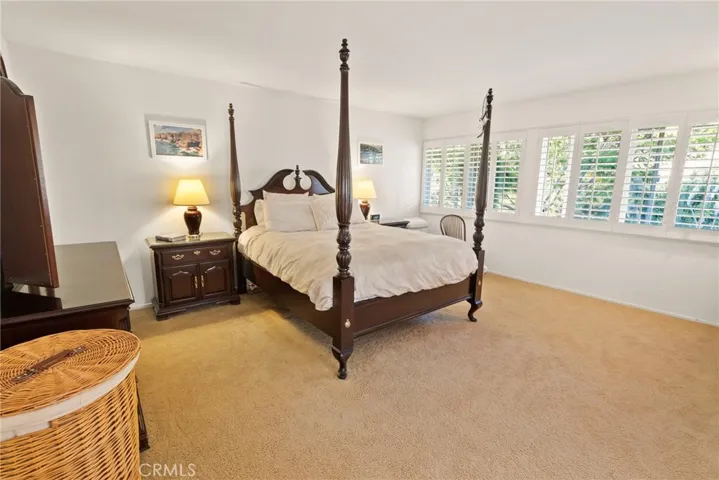 On the Second Floor there are three of the four bedrooms and this is the larger Primary Bedroom which looks out over vegetation.
