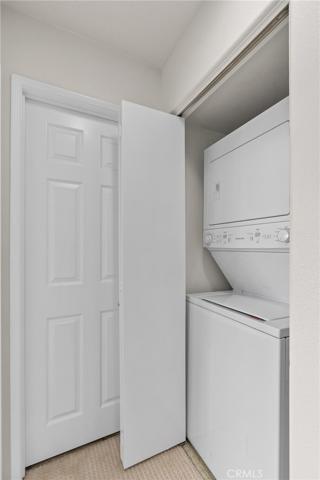 Convenient laundry with a stacked washer and dryer!