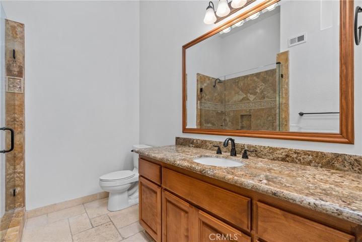 Check out the ensuite bathroom with a glass-enclosed shower and skylight!