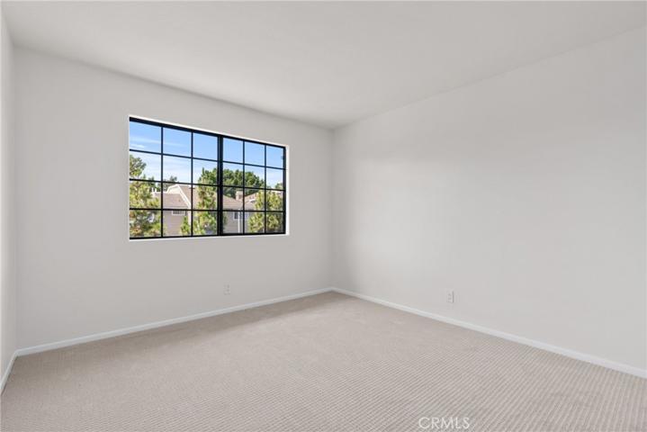 The secondary bedroom is perfect for guests or family.