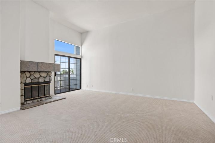 Step in and notice the high ceilings and a cozy fireplace!