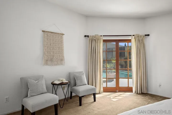 Primary bedroom is on the first floor with doors leading to backyard and courtyard.