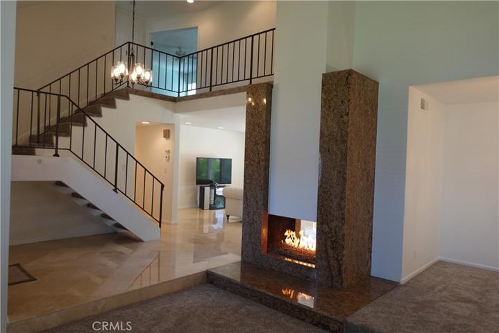 Living Room with Granite Face Two Sided Fireplace