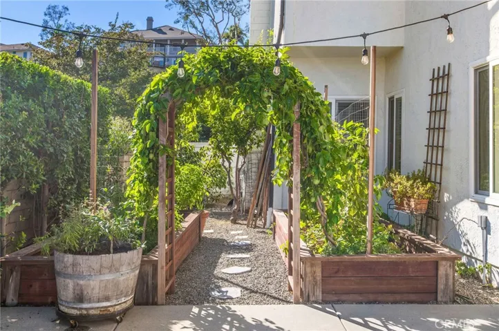 arched trellis leads you to the large lovely garden area
