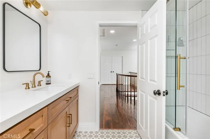 tub/shower combo with beautiful tile and sliding glass door