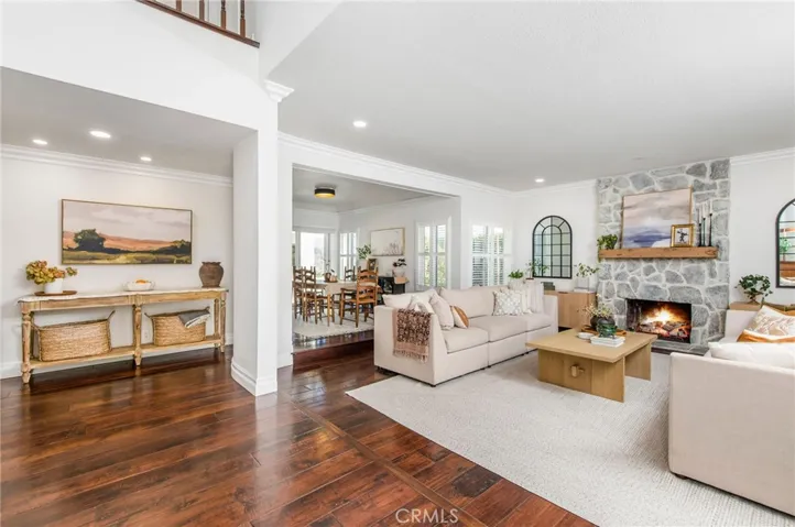 open and spacious entry, living and dining areas with beautiful wood flooring