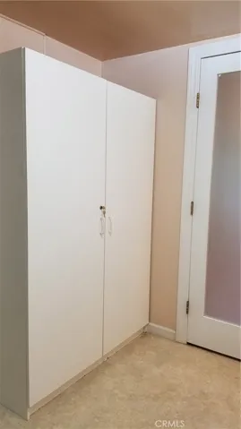 Inside bathroom. Large storage cabinet.