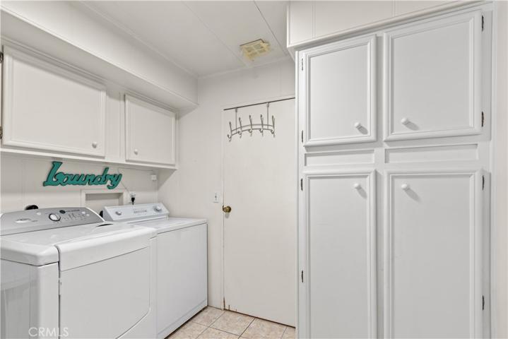 Separate laundry room with storage