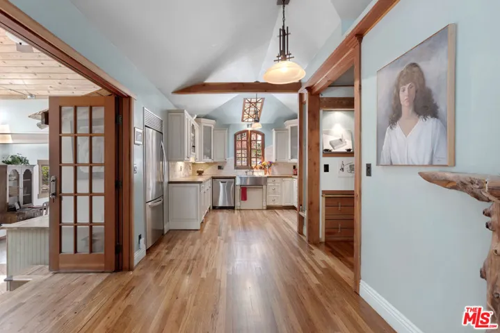 Kitchen ahead, Den to the right, Dining/Studio/Family Room on left & Secondary Entry