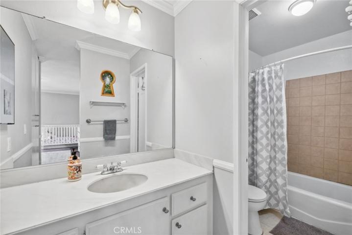 Secondary master ensuite bathroom with linen cabinets.