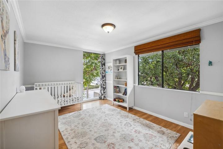 Secondary Master with  floor to ceiling windows  that frame a lush leafy canopy for ultimate privacy.  Walk in closet.