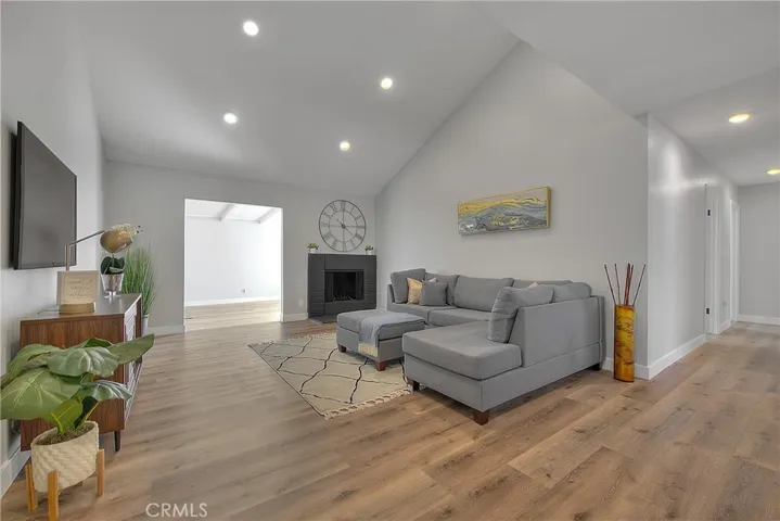 Living Room w/Fireplace. New Laminate waterproof flooring throughout the home.