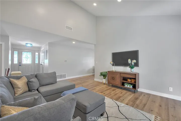 Living Room w/Fireplace. New Laminate waterproof flooring throughout the home.