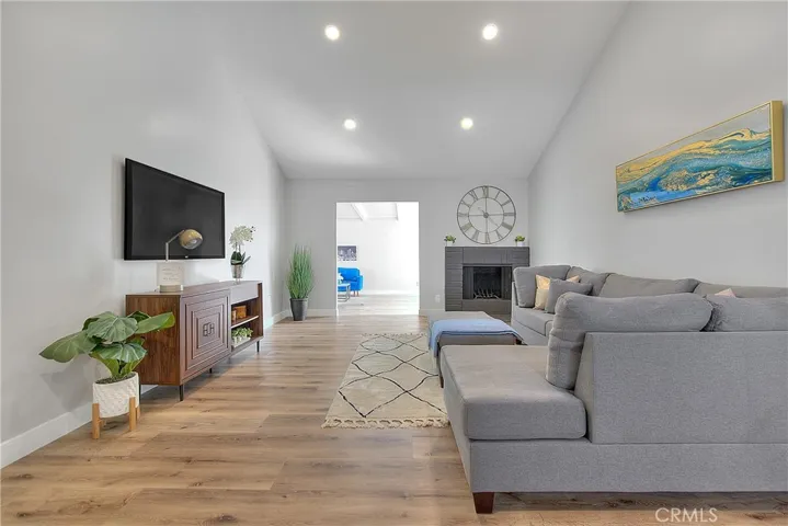Living Room w/Fireplace. New Laminate waterproof flooring throughout the home.