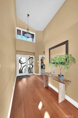 Entrance with rich Mahogany floors and Glass front doors