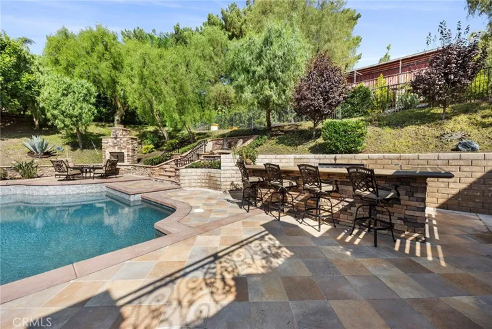 Stacked stone BBQ has a separate grill, refrigerator, sink, and storage area.