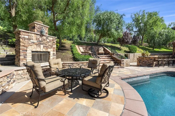 Outdoor fireplace with perfect spot to enjoy the all the entertaining going on