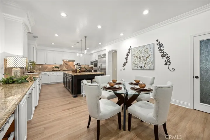 This kitchen is a cooks dream, large expresso contrasting island with vegetable sink, double drawer dishwasher, all kinds of storage, walk-in pantry with separate walk-in storage area, bultlers pantry, upgraded faucets, wine rack, pot filler, and looking out to an incredible backyard