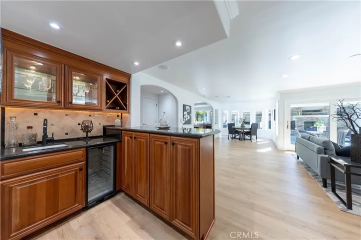 Gorgeous wet bar with plenty of cabinets and a wine refrigerator.