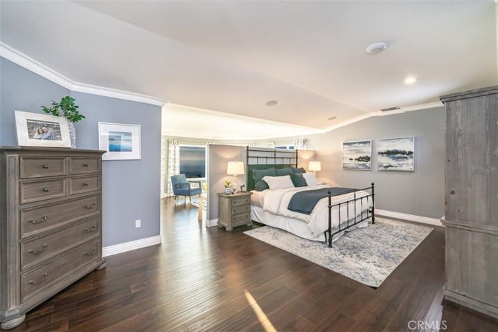 Primary bedroom with 3/4 wall leading to sitting area