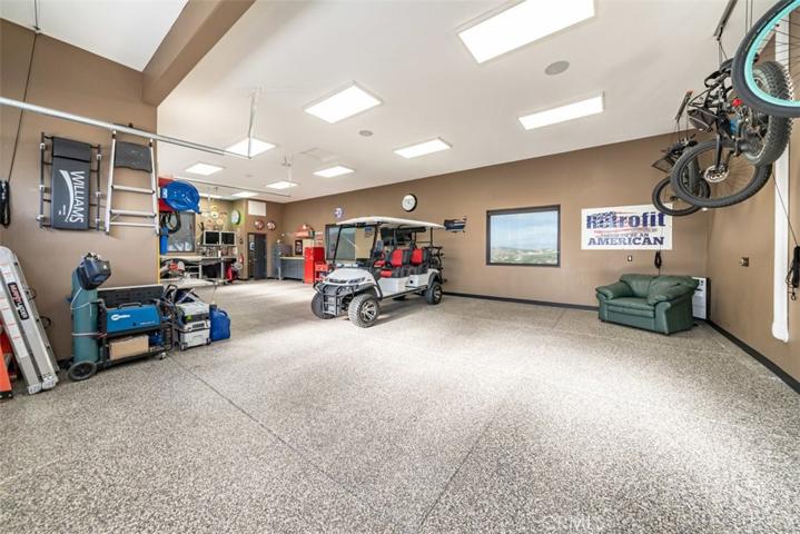 Detached air conditioned 4 car garage w/shop, 1/2 bath and bunker/storage