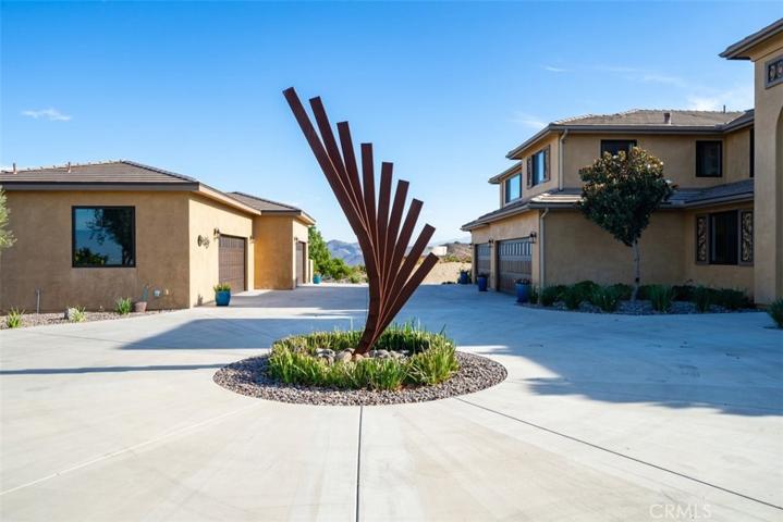 Circular driveway sculpture with 8 car garages in the distance