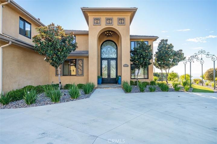 Grand entry with  custom iron doors and transom above