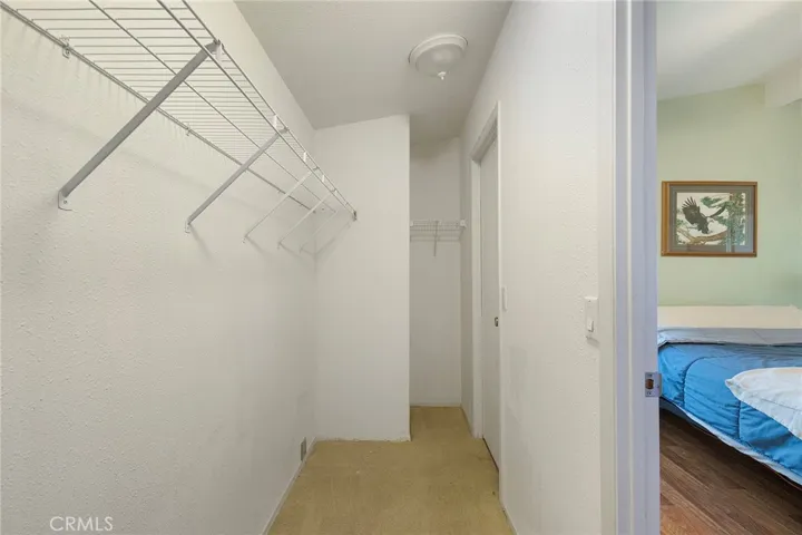 Walk in closet with two doors.