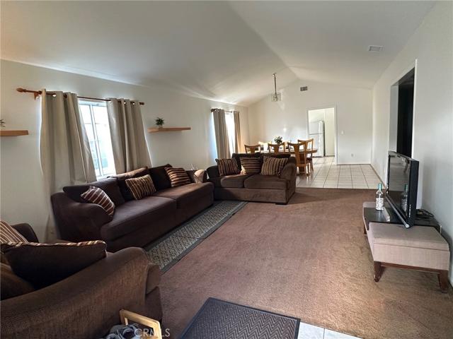 Living room with view to dining area and kitchen