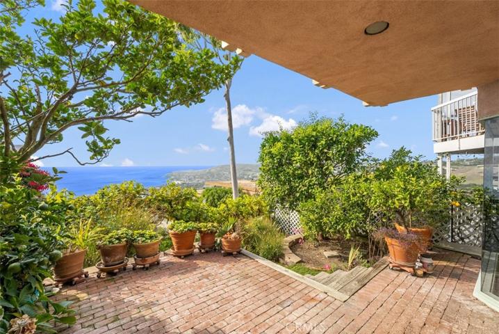 Bricked patio and lush backyard
