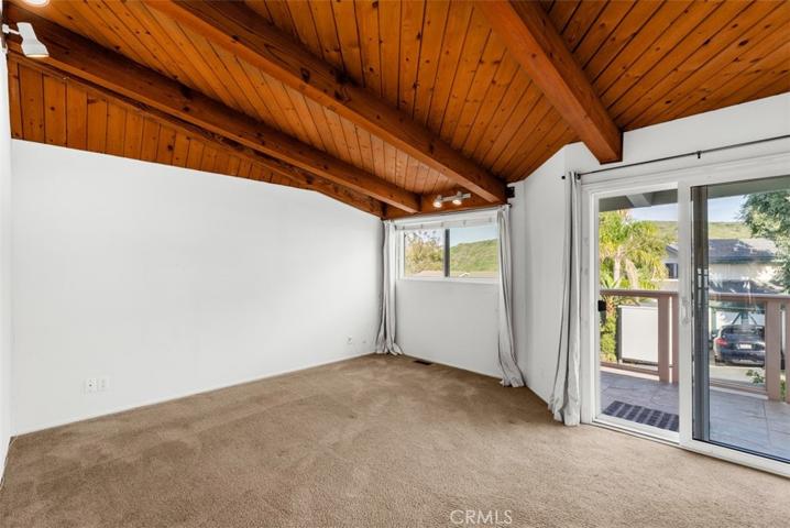 Main level bedroom with balcony