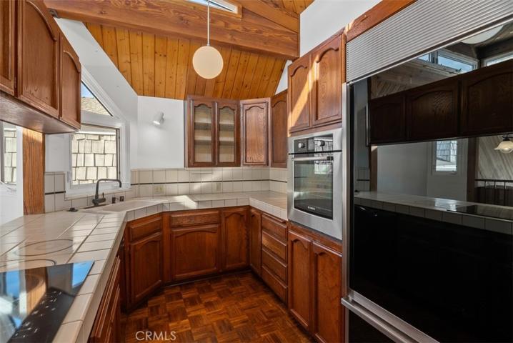 Galley kitchen with parquet flooring