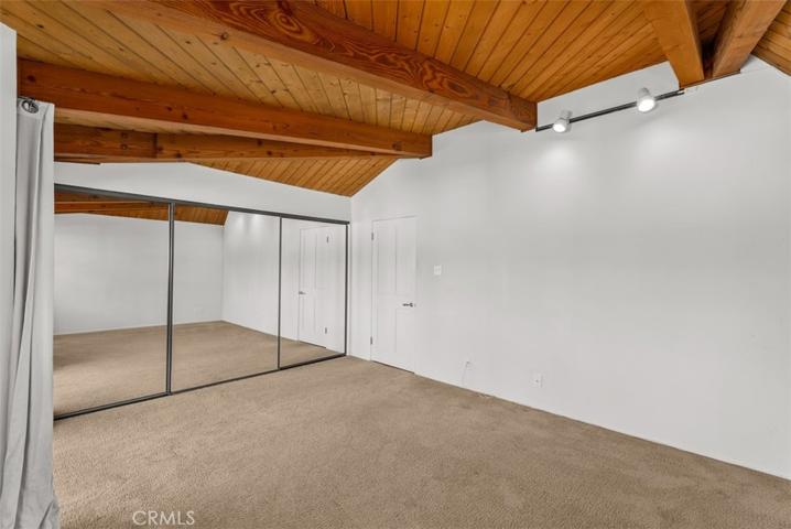 Spacious bedroom with beamed ceilings