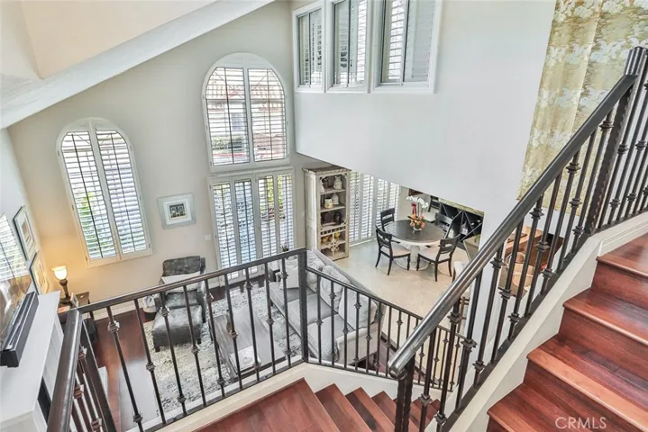 Stair Case looking into living room , high ceilings