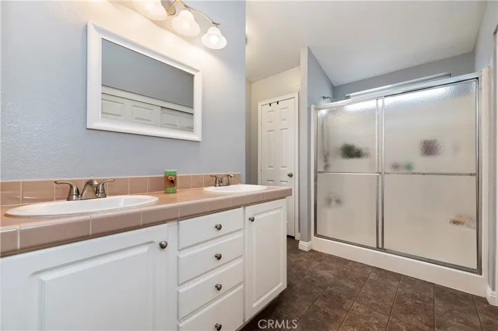 Main Bath with stand up shower and dual sinks.