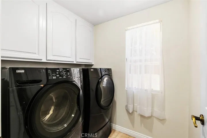 Laundry room with full size washer/dryer.