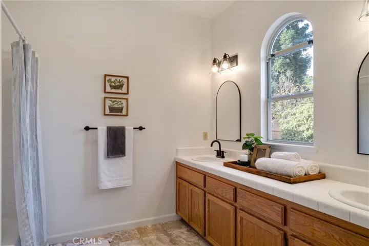 Primary bathroom. Toilet is not shown but is directly to the left of where photographer was standing, inside the primary bathroom.