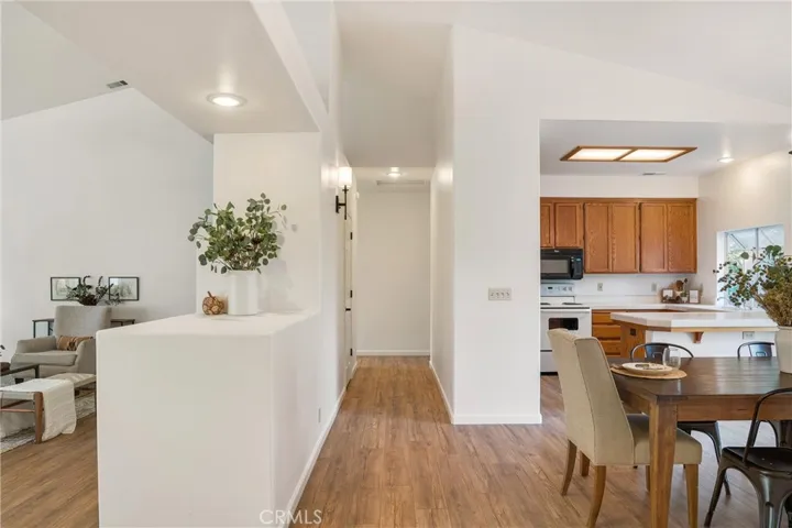 Hallway to the left when facing the dining. Leads to 2 bedrooms and a full bathroom.
