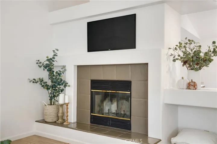 Fireplace in living room with wood storage directly to its right.